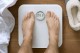 Fitbit Aria Wi-Fi Smart Scale: above,-white,-wood,-male,-slippers+robe-b